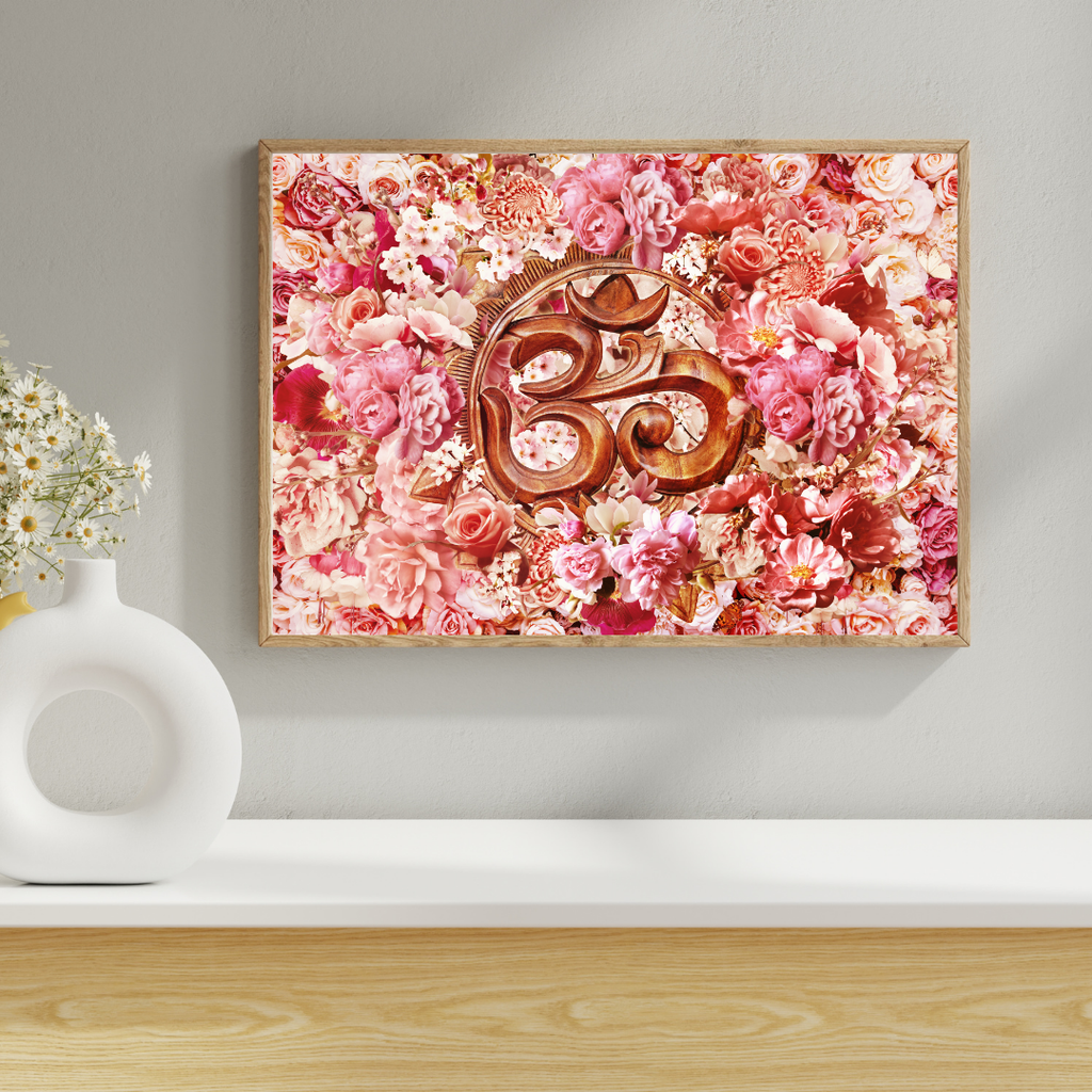 Framed artwork with floral design and wooden symbol on a wall above a white shelf.