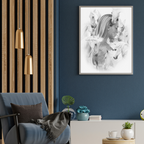 Modern living room with a blue armchair, gold pendant lights, and a framed artwork on the wall.