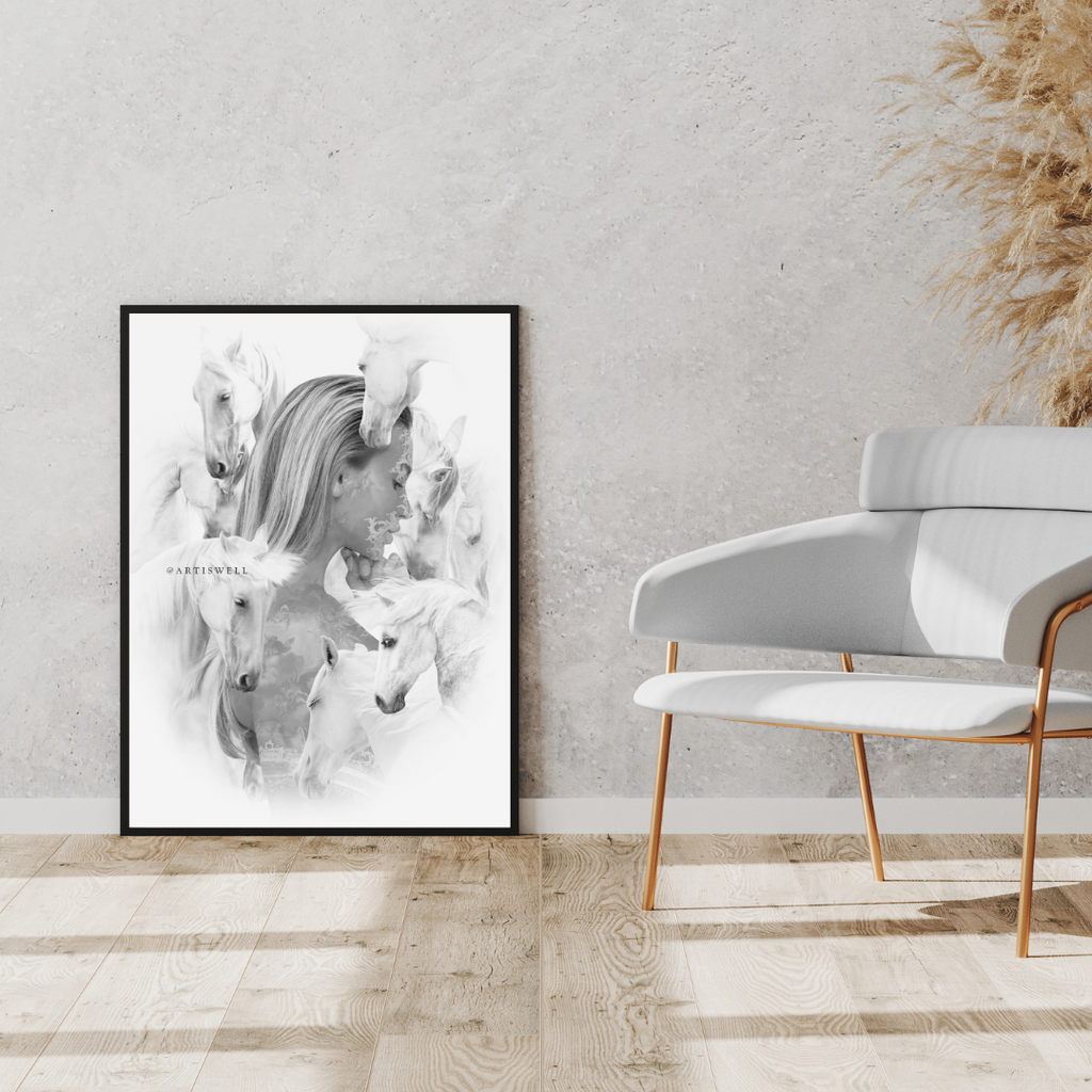 Framed black and white artwork of horses on a wall in a modern interior setting with a chair and decorative plants.