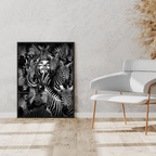 Framed artwork of zebras on a wall in a modern interior setting with a white chair and decorative plants.