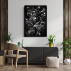 Modern interior with a large black and white dekozi original artwork on the wall featuring elephants with a girl, a chair, and decorative plants.